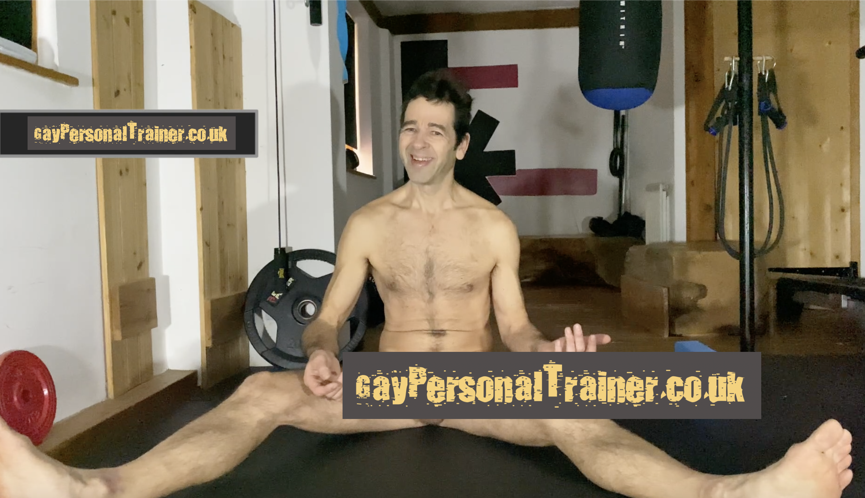 gay personal trainer naked on the floor with some writing to hide penis from view